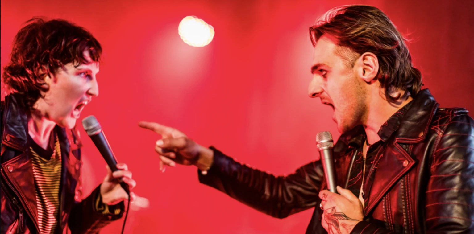 Doom Boogie: two musicians confront each other on a red-lit stage